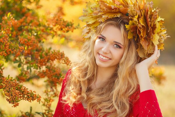 A girl with a wreath of maple leaves