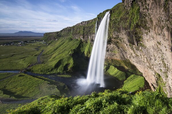 Waterfall in Iceland on the background of a rock