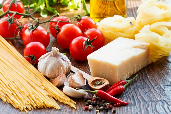 A dish of spaghetti, cheese and tomatoes