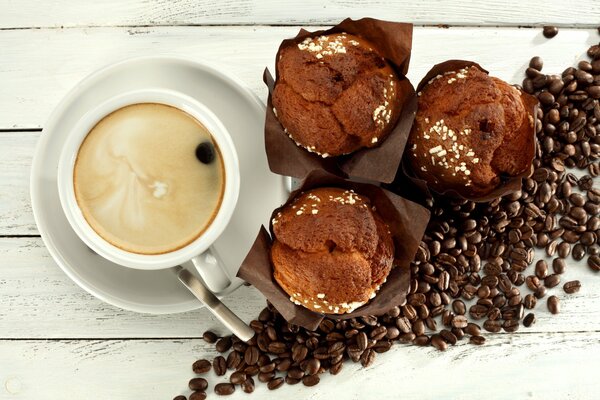 A cup of fragrant coffee with a cupcake for breakfast