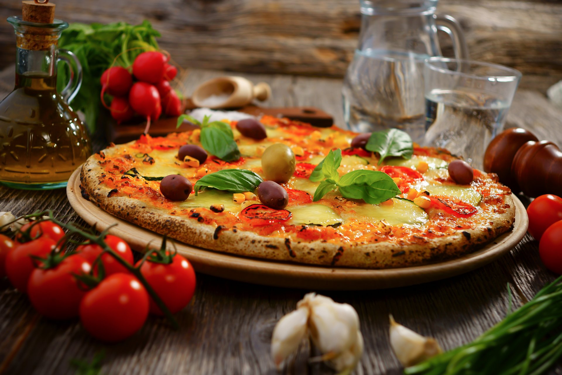 pizza olives cheese tomatoes garlic radish vegetables water oil dish food