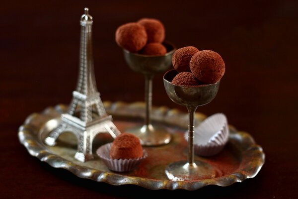 Truffle candies in glasses. Mini replica of the Eiffel Tower