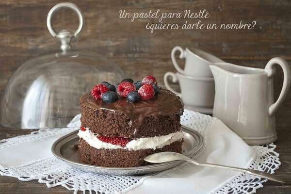 Chocolate dessert with white cream decorated with raspberries and blueberries