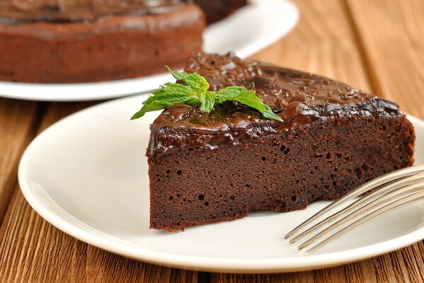 Brownie decorated with mint on a plate