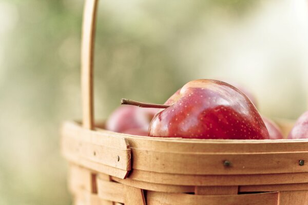 Basket with apples on a blurry background