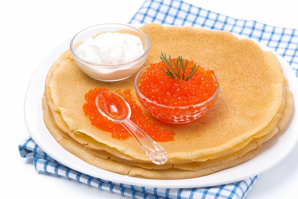 Pancakes with red caviar and sour cream