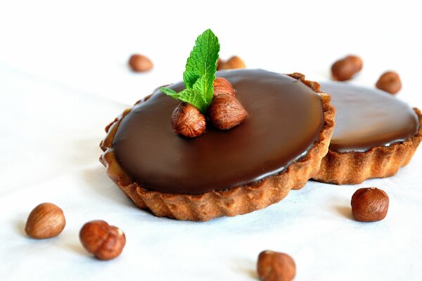 A basket with chocolate decorated with hazelnuts