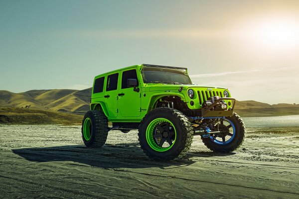 Jeep rides on the sand near the hills