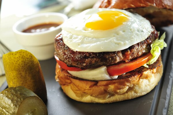 Layered burger with egg and tomatoes