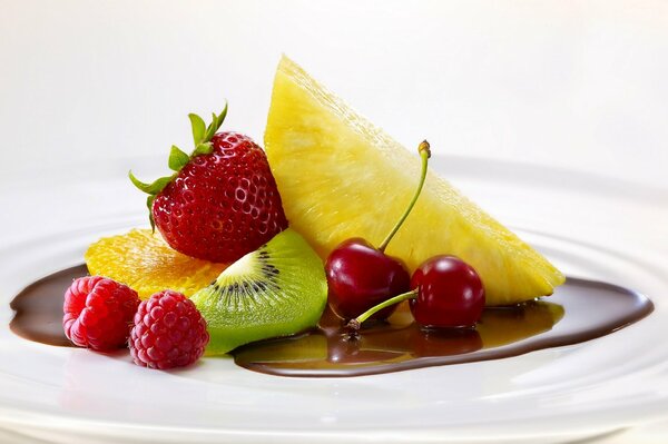 There are sweet fruits and chocolate on the plate