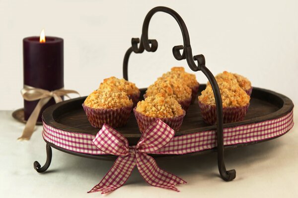 Muffins on a tray and a candle on the table