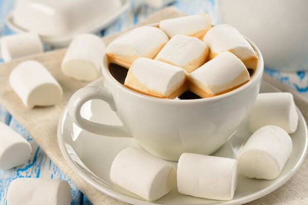 Coffee with marshmallows in a white cup and saucer