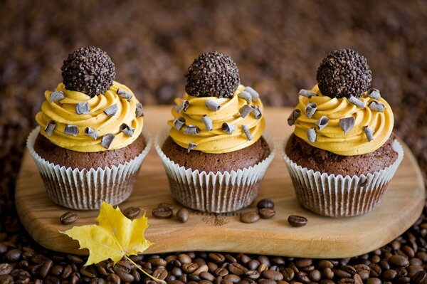 Cupcakes with truffles on a wooden board