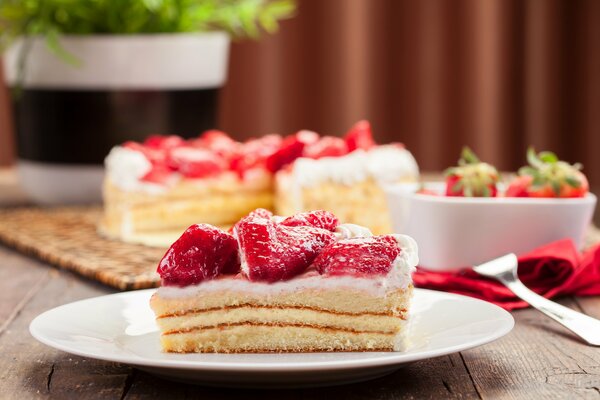 Pieces of cake with strawberries on a plate