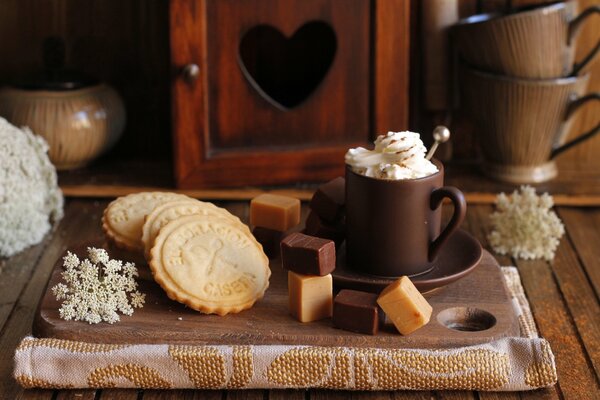 A cup of coffee and cookies in brown tones