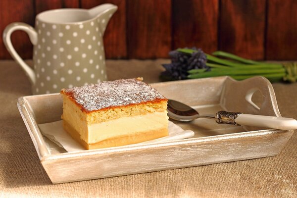 Layered dessert with powdered sugar on a tray