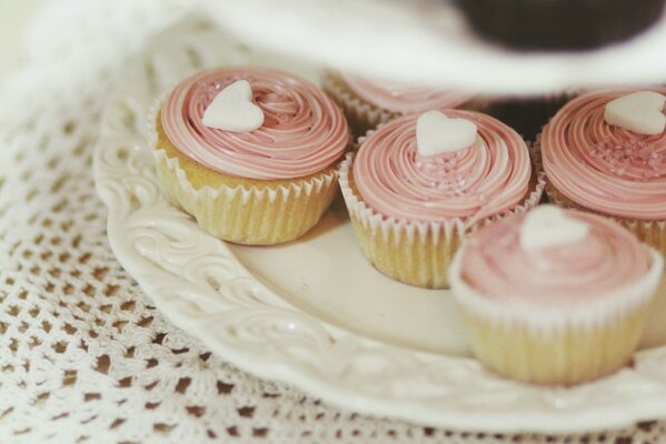 Cupcakes with pink cream and sugar hearts