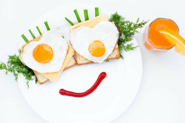 Creative breakfast in the form of a cheerful face made of scrambled eggs