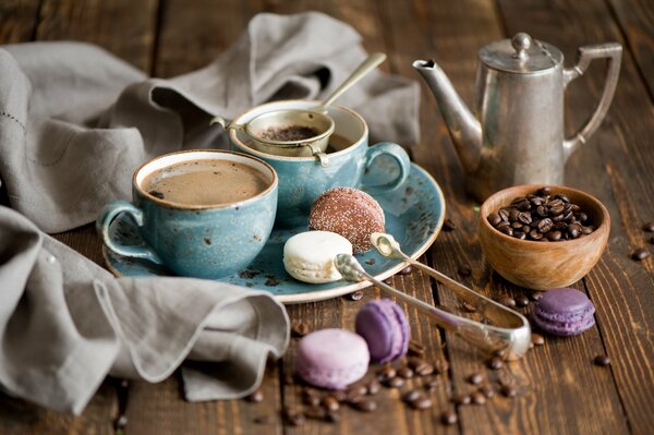 Still life with a coffee pot and tongs and cakes