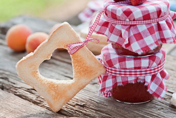 Jam in a jar with a piece of bread