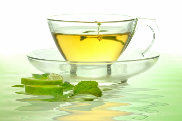 A cup of green tea with lime and mint
