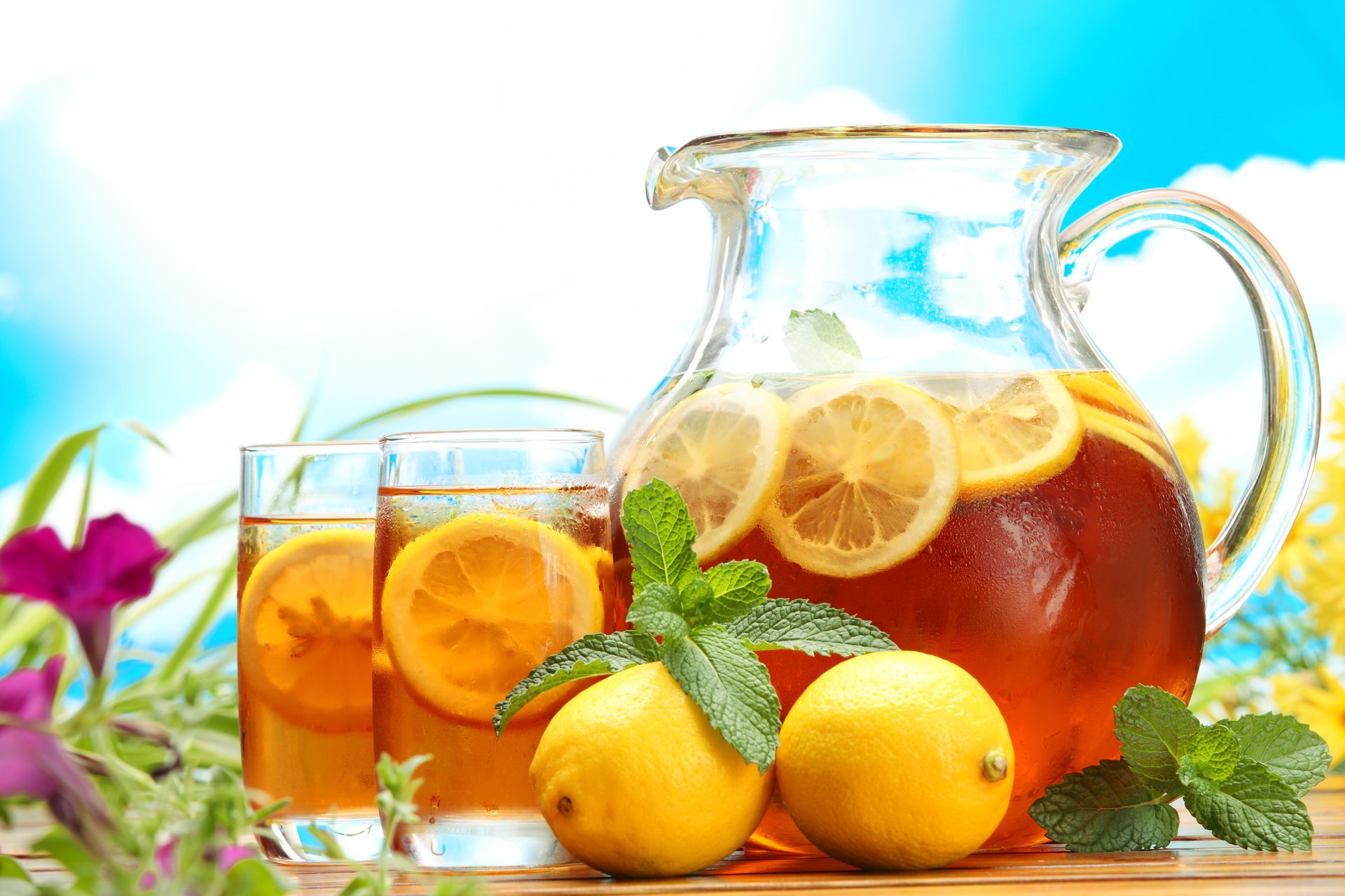 table carafe napkin glasses tea ice tea drink lemons mint sky