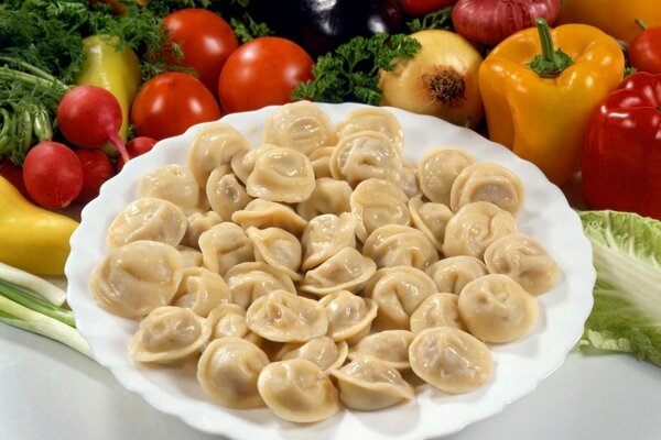 Fragrant dumplings on the table with vegetables