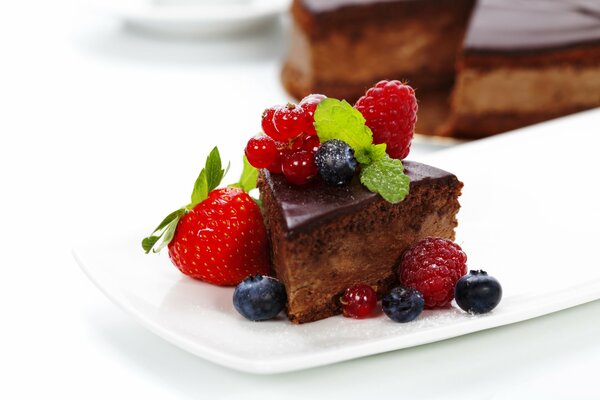 Delicate cake in chocolate glaze with berries