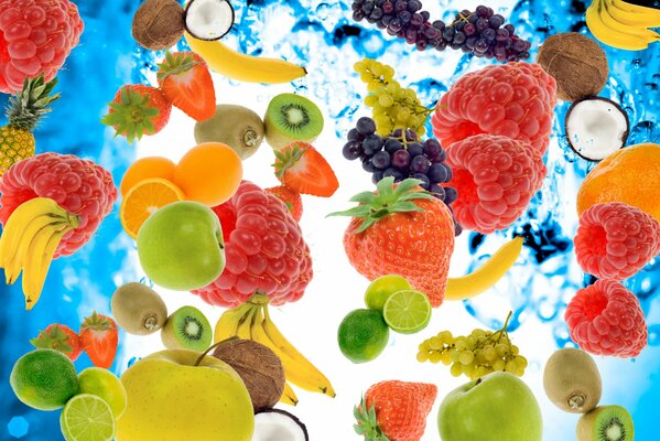 On the background of water fruits and berries raspberry kiwi strawberry banana grape apple pineapple coconut orange lime tangerine