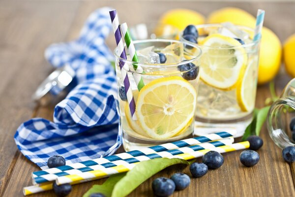 Homemade lemonade with blueberries in cups with tubes