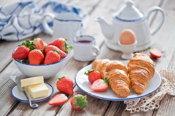 Tea with croissants and strawberries for dessert