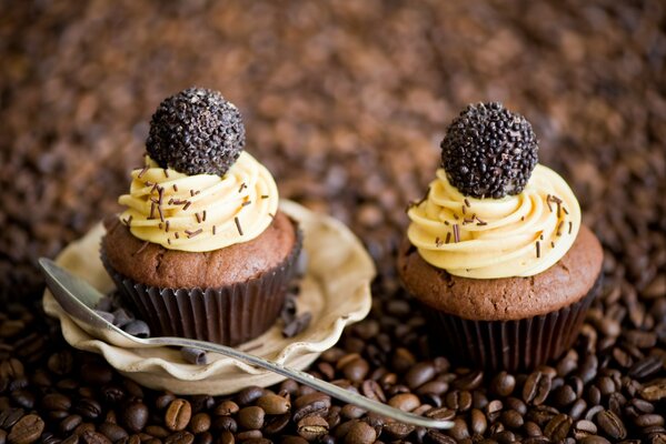 Chocolate cupcakes with cream on the background of coffee beans