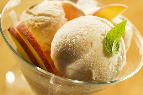 Ice cream balls with orange slices and mint leaf