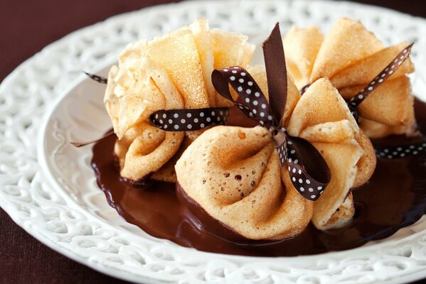 Pancakes in chocolate with elegant bows