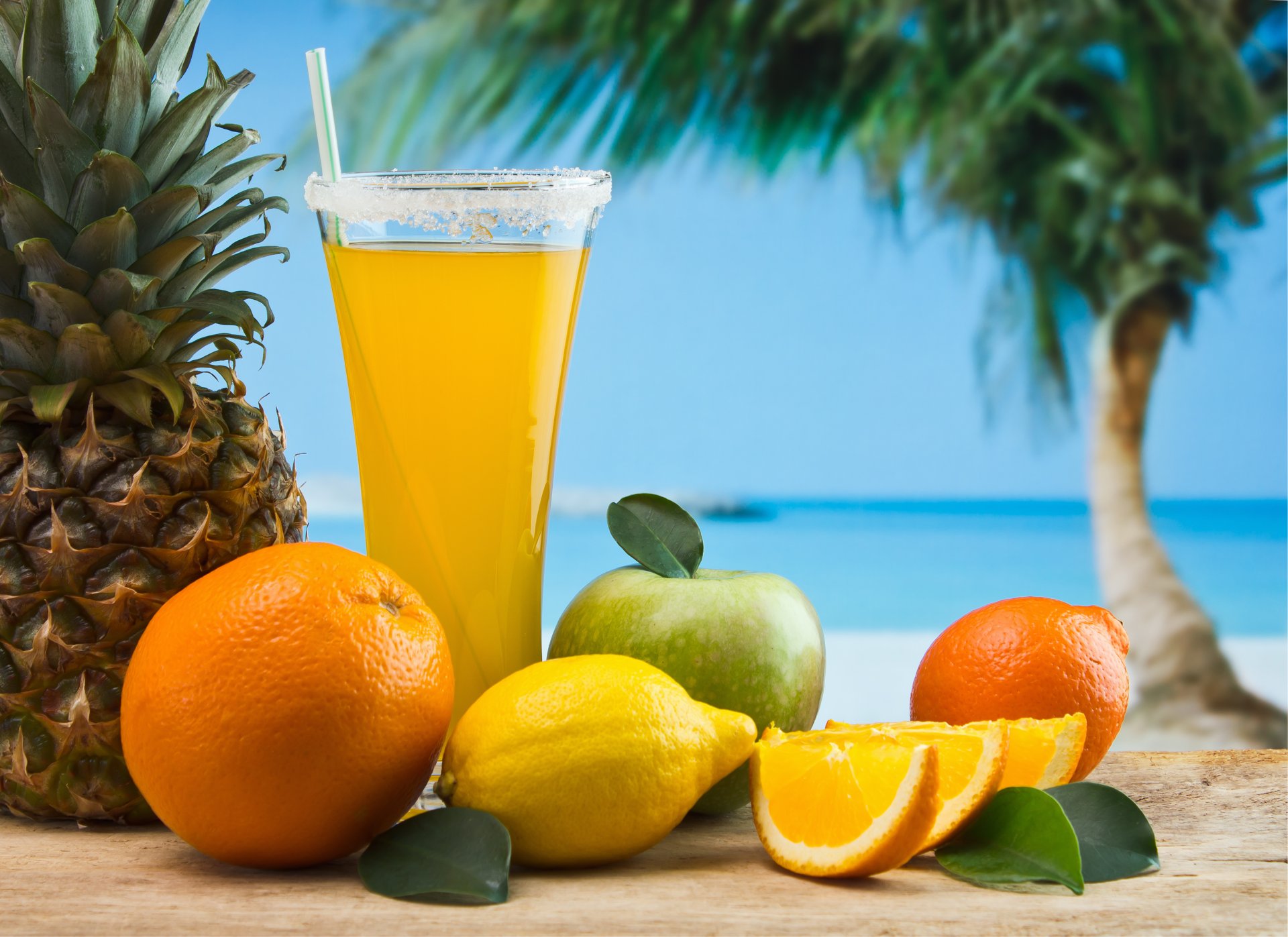 glass juice tube fruits pineapple lemon apple orange appetizing palma sky sea sand