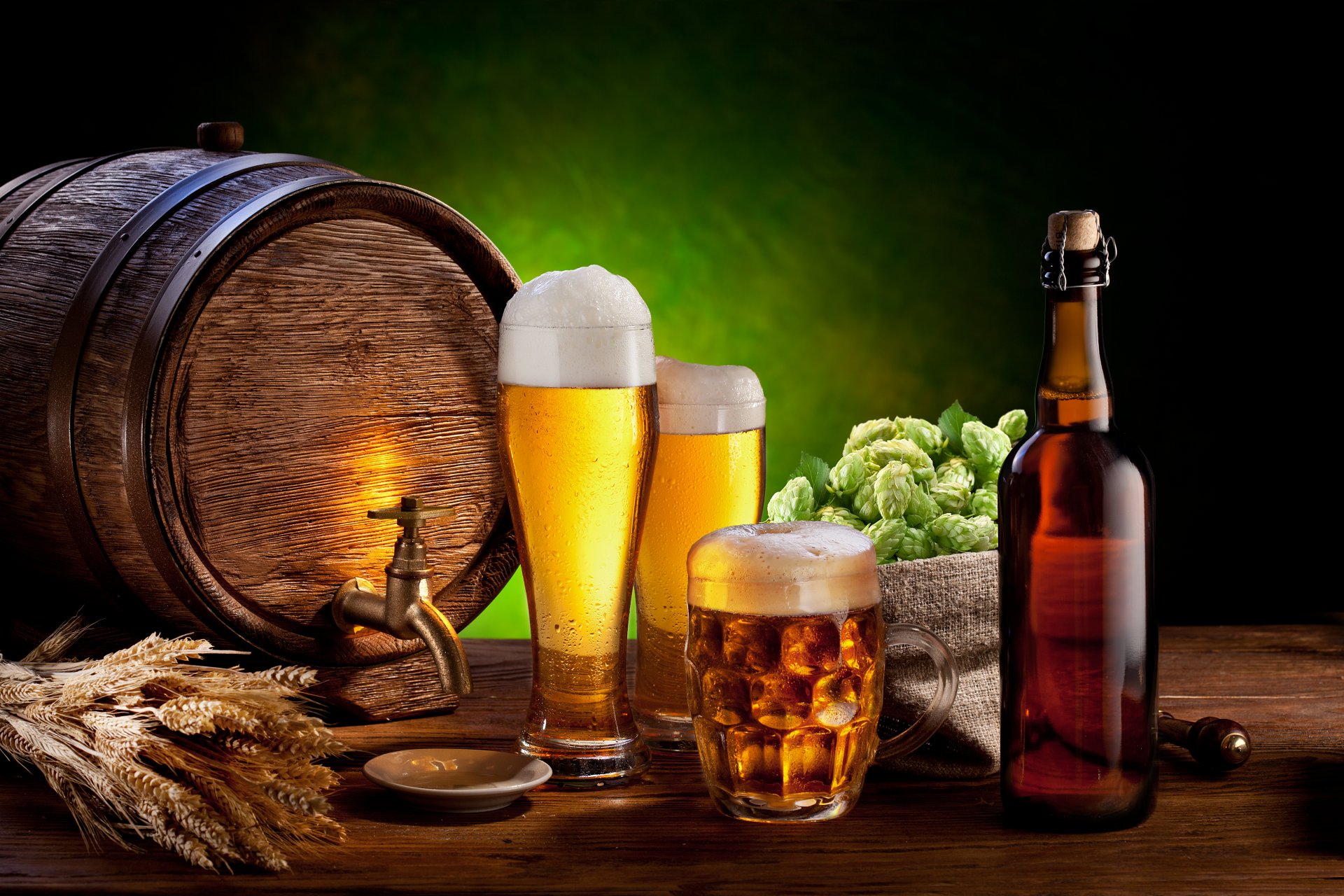 barrel a bottle glasses mugs beer foam ears table