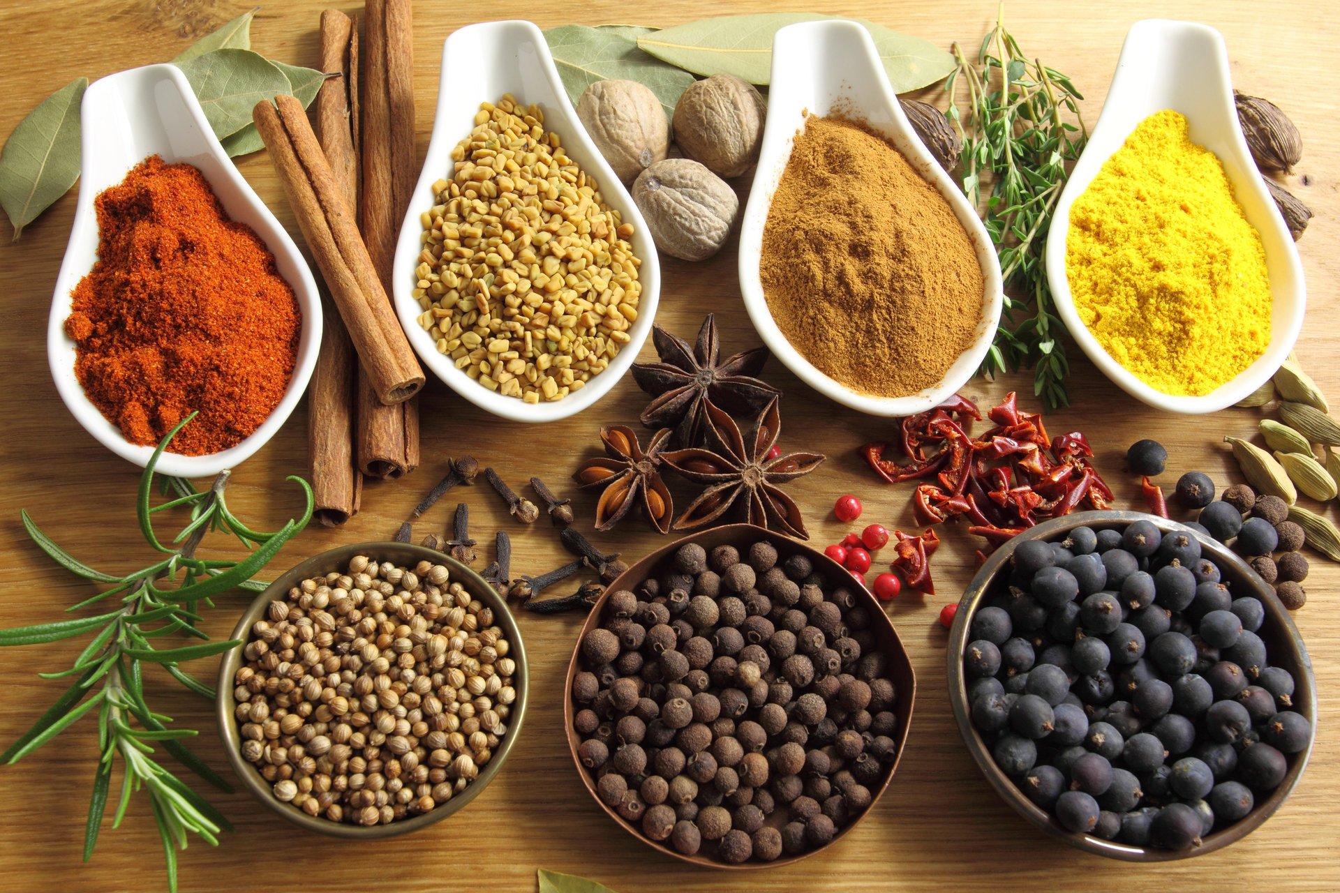 table bowls spices cinnamon red pepper black pepper star anise curry coriander green