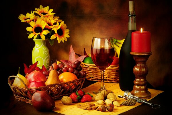 Still life of baskets with pears, apples and bananas, walnuts and hazelnuts and a glass of wine standing on the table, a red thick candle on a candelabra and a bottle of wine