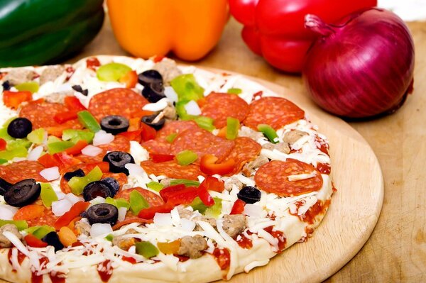 Delicious, juicy pizza with pepper, mushrooms and olives