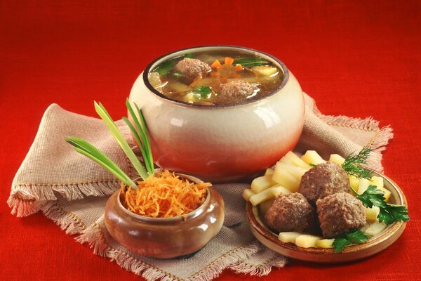 Russian lunch of soup and potatoes with meatballs