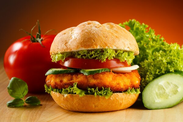 Hamburger on the background of vegetables and greens