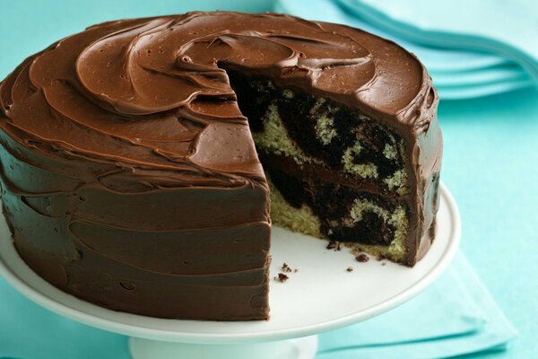 Chocolate cake on a plate. Blue background