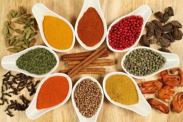 Multicolored spices in bowls are