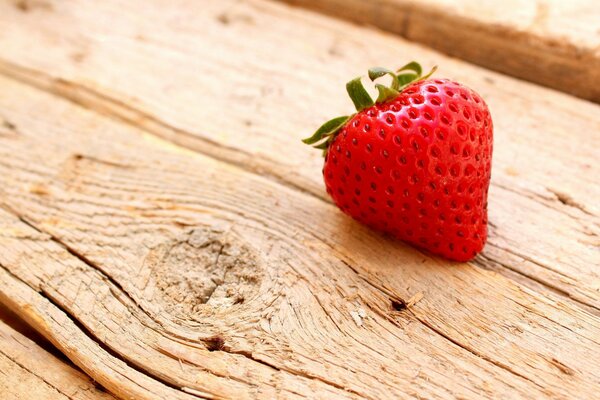 Strawberry berry on a wooden table