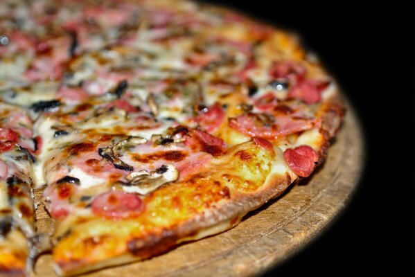 Delicious pizza with mushrooms and ham