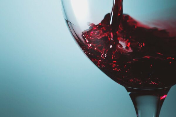 A glass of wine on a blue background