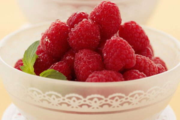 Plate with ripe raspberries