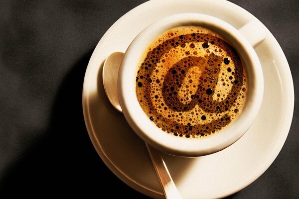 A cup of coffee with a dog symbol on the foam