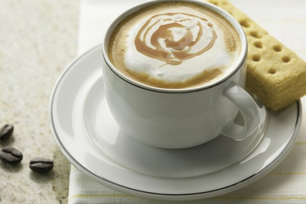 Coffee mug with white cookies on a saucer