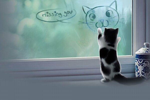 A small kitten on the windowsill is playing with an image on the glass